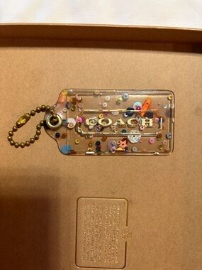 Coach Clear Confetti Logo Tag with Gold Ball Chain